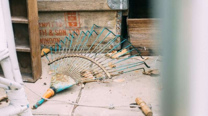 rake on pavement beside box